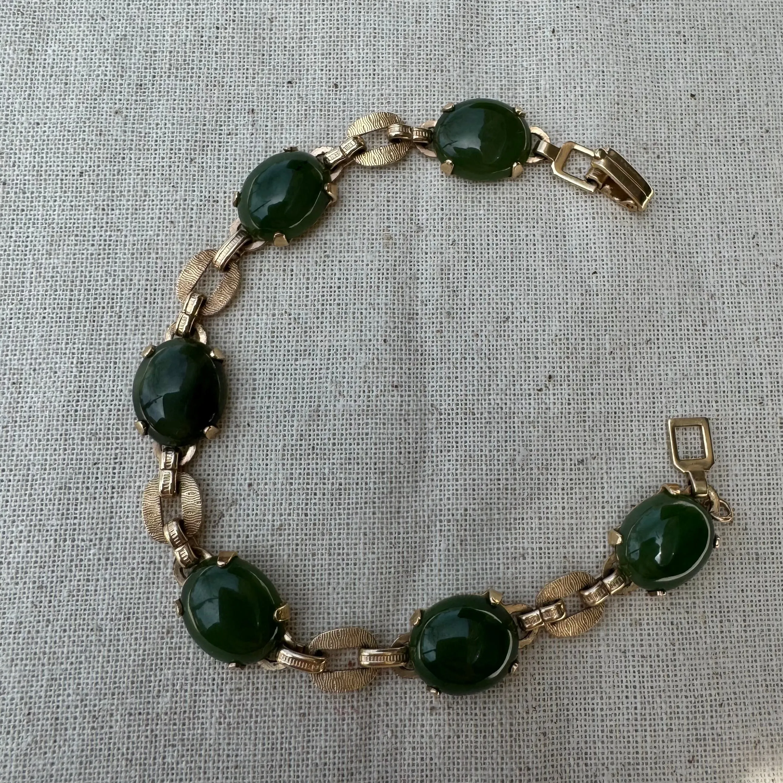 14K gold bracelet set with oval green Jade cabochons and textured gold links