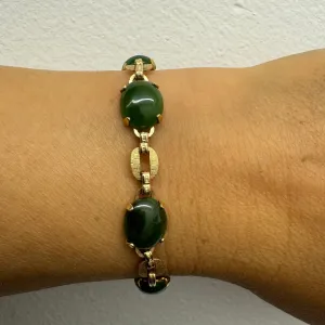 14K gold bracelet set with oval green Jade cabochons and textured gold links
