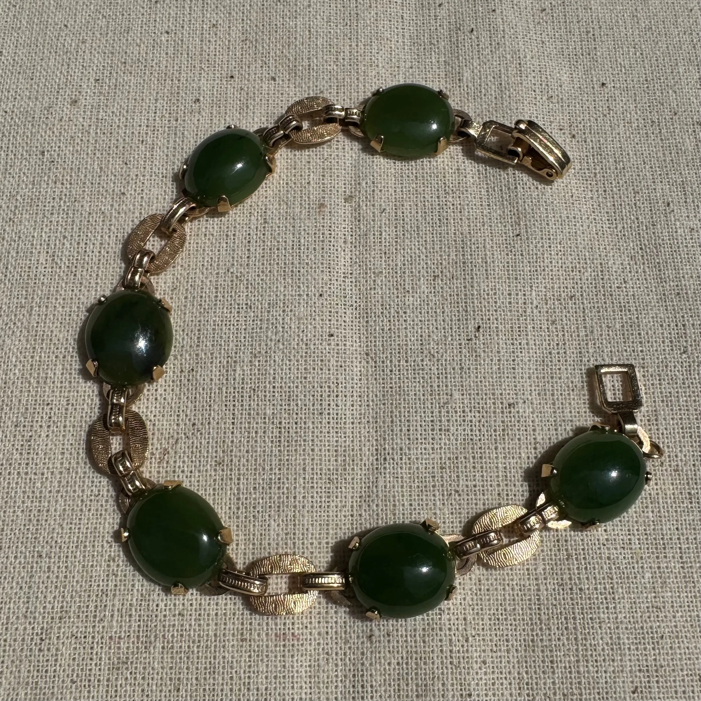 14K gold bracelet set with oval green Jade cabochons and textured gold links