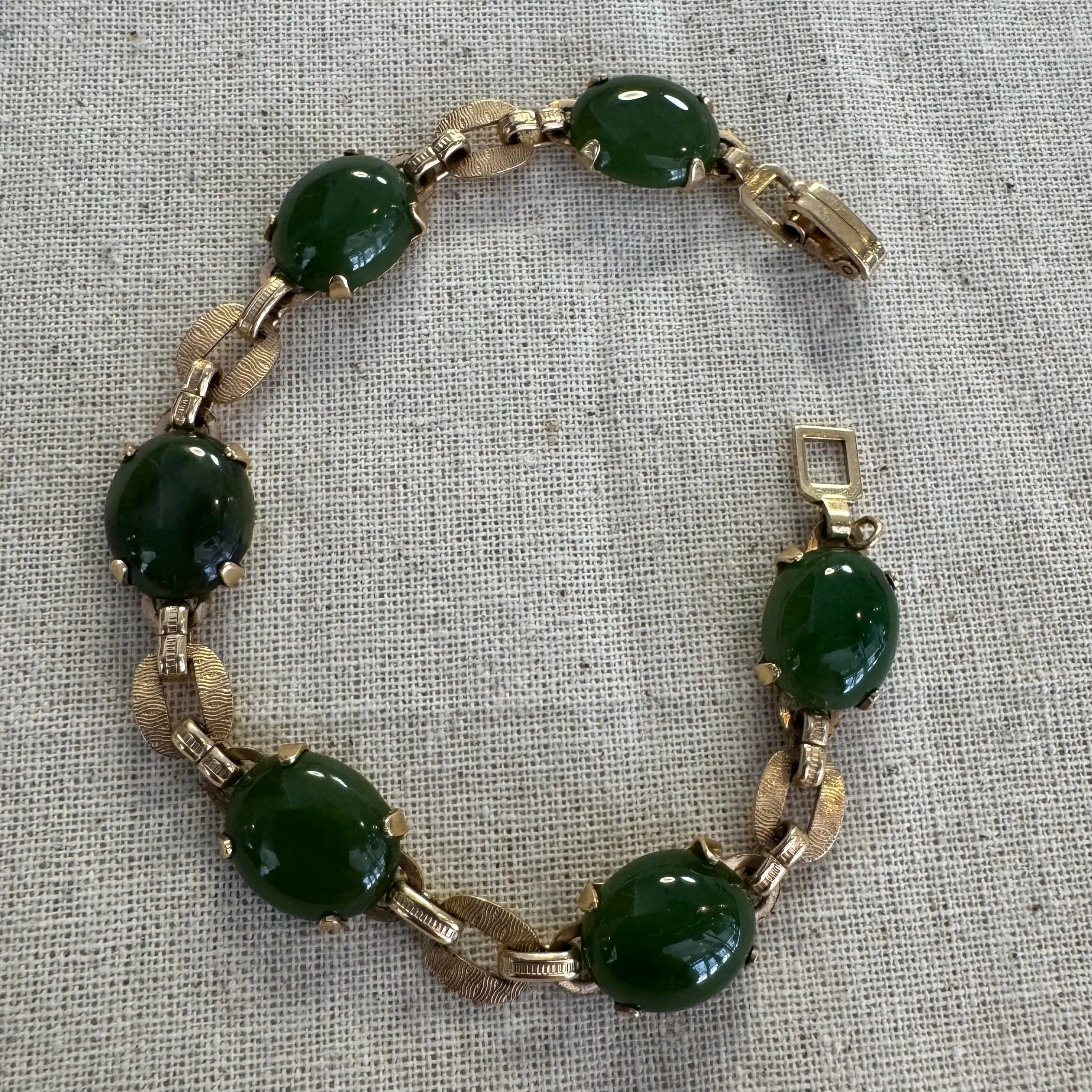 14K gold bracelet set with oval green Jade cabochons and textured gold links