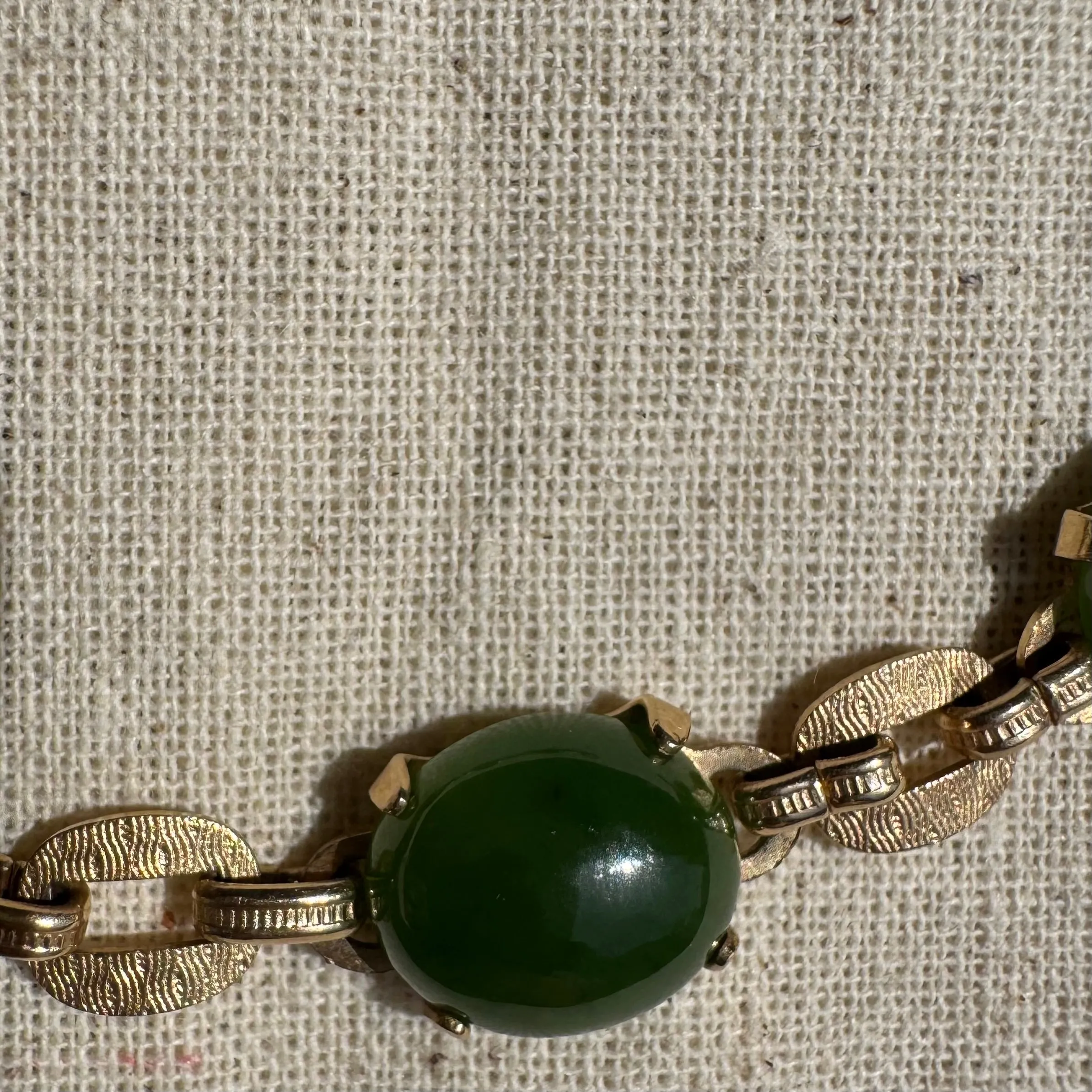 14K gold bracelet set with oval green Jade cabochons and textured gold links