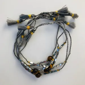 TM. String Bead & Tassel Bracelet