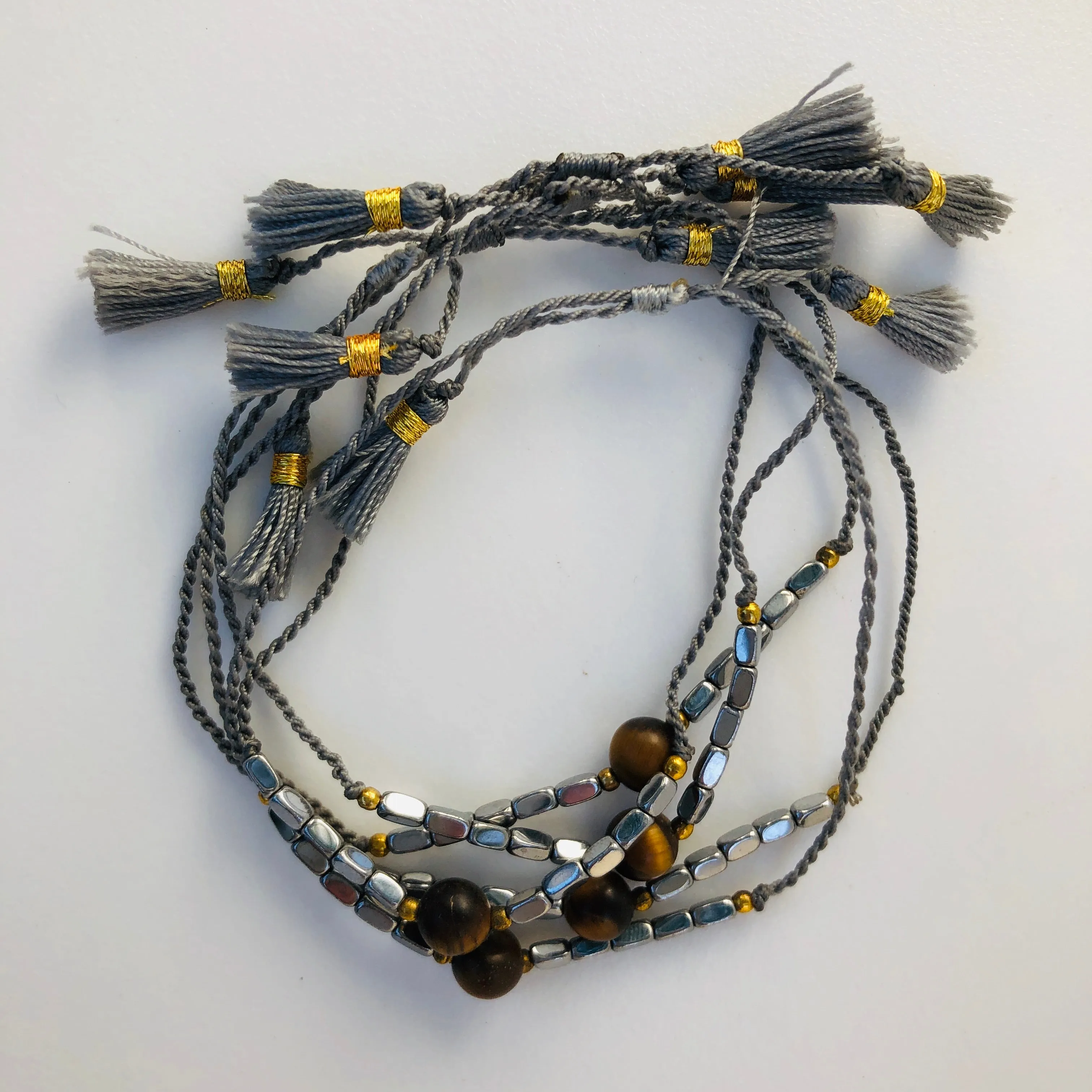 TM. String Bead & Tassel Bracelet